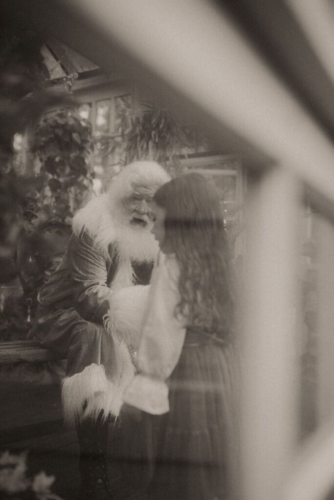 A little girl talking to hippie Santa at Das hinterhaus in Marietta, GA. 
