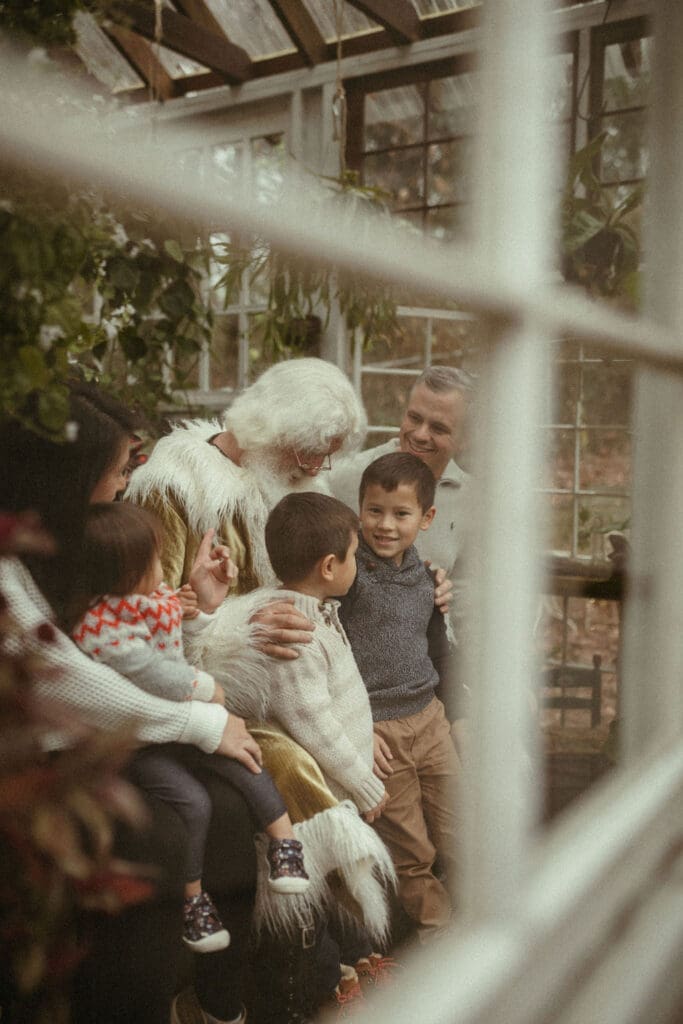 A family standing with Santa at Das Hinterhaus. 