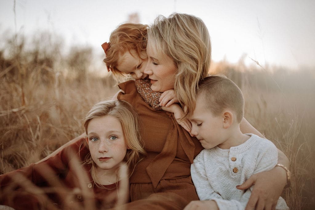 A mother with her three young children. 