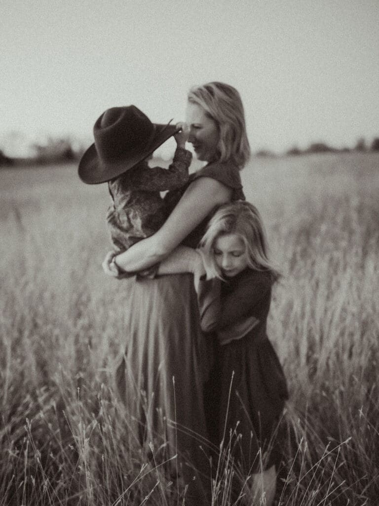 A mom standing with her two girls. 