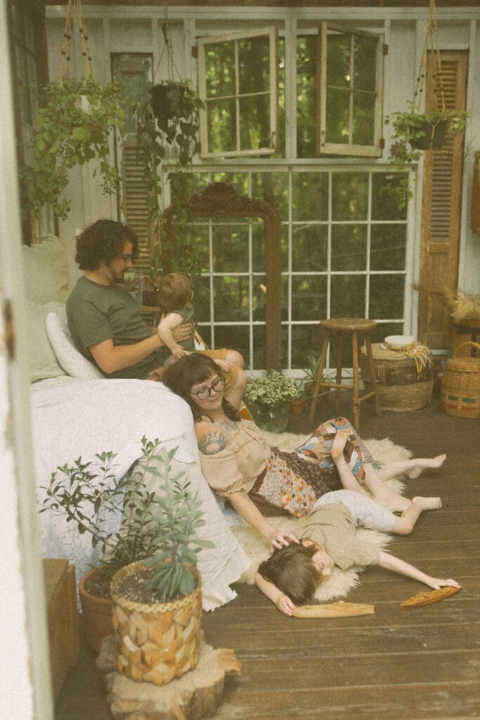 Calm, unposed family photography moment in soft spring light at Das Hinterhaus greenhouse