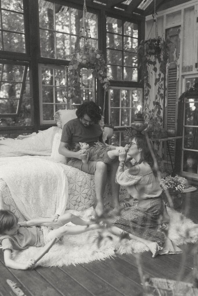 Calm, unposed family photography moment in soft spring light at Das Hinterhaus greenhouse