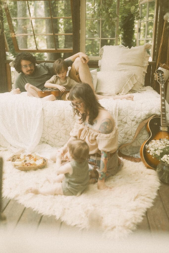 Mother snuggling her children during an unposed greenhouse family photography session