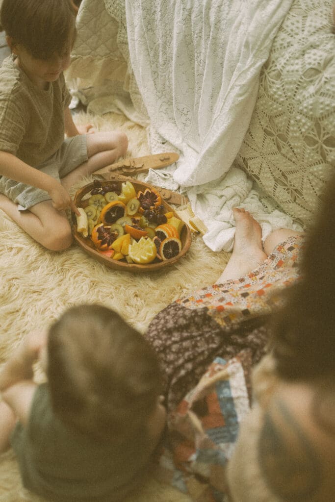 Nostalgic lifestyle family photography details with fruit, wine glasses, and soft textures
