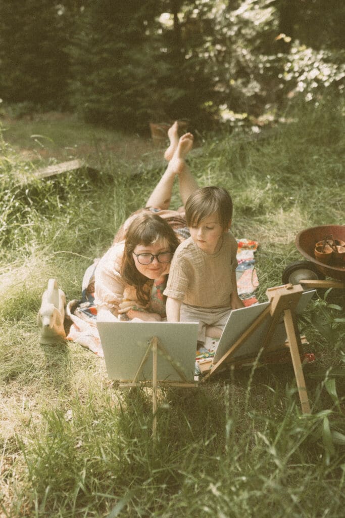 Child-led lifestyle family photography with kids painting during a spring greenhouse session