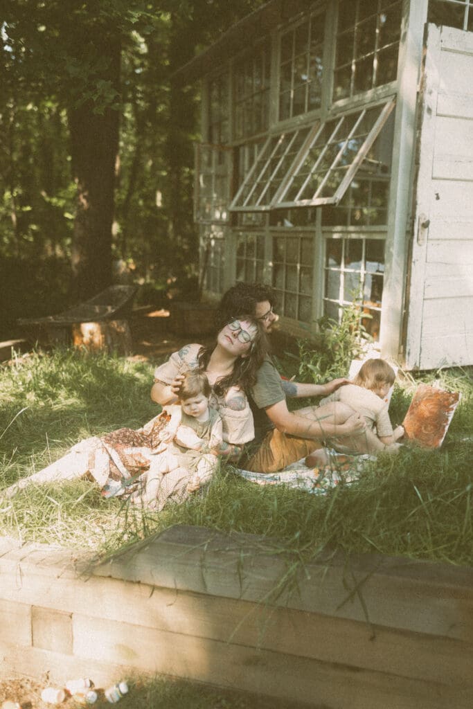 Calm, unposed family photography moment in soft spring light at Das Hinterhaus greenhouse
