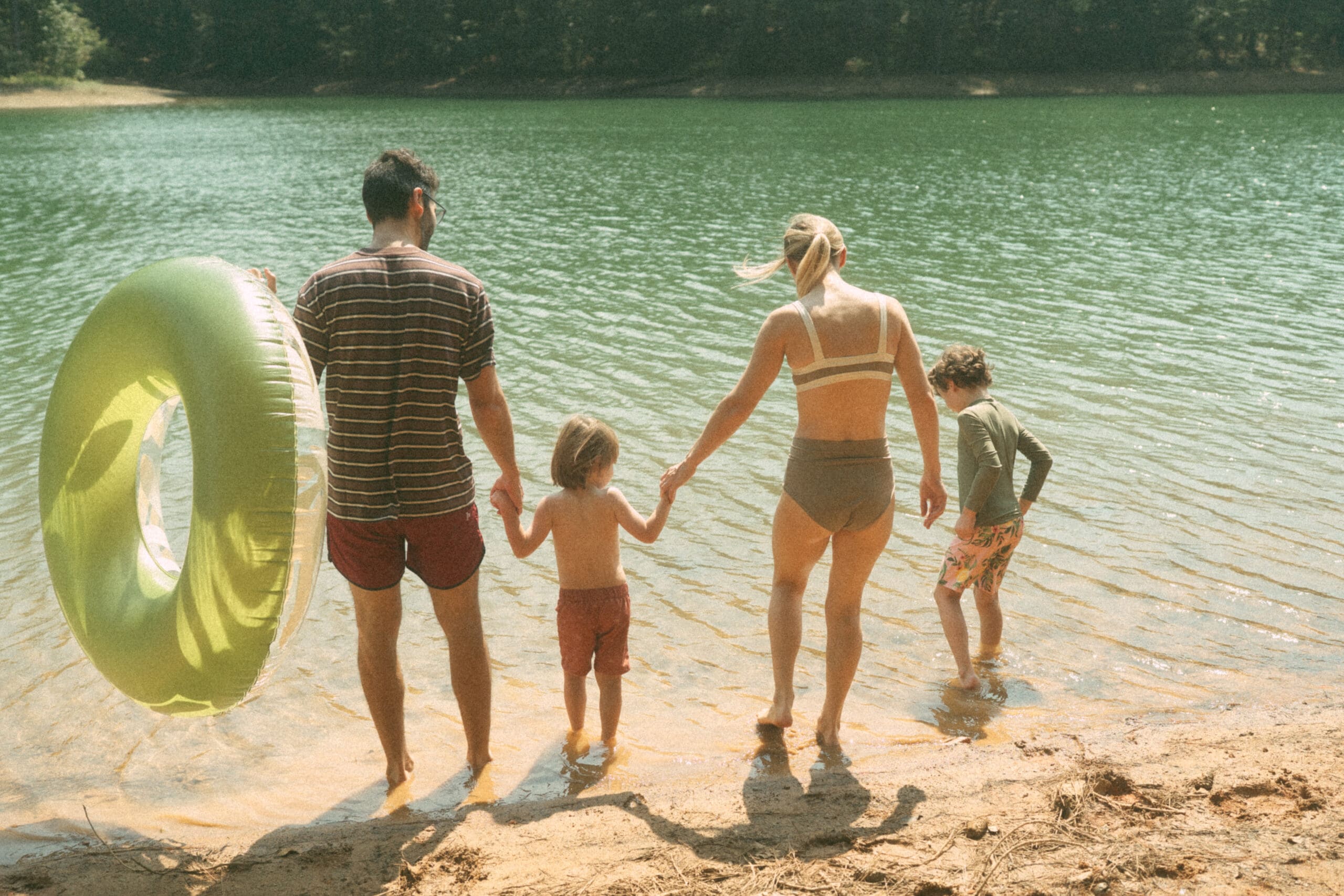 family trip playing on the beach of Lake Allatoona, getting ready to enter the water