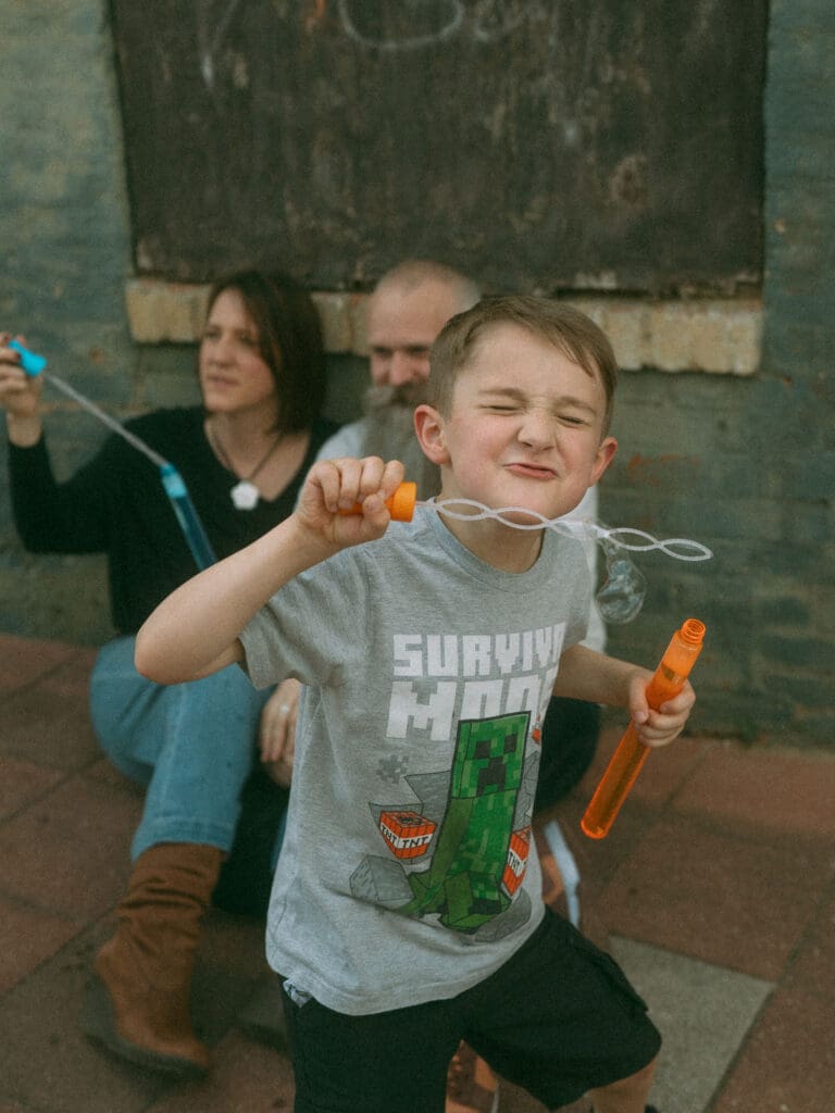 little boy with scrunched up nose blowing bubbles- acworth, ga