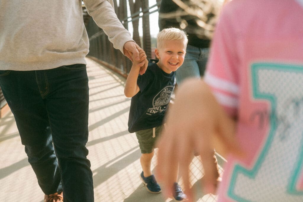 family runs and youngest brother is framed in the middle with a big smile